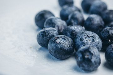 fresh blueberry berries on a white plate close-up. breakfast of wild berries. copy space