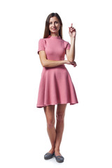 Full length woman in pink dress pointing up