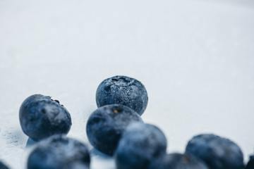 fresh blueberry berries on a white plate close-up. breakfast of wild berries. copy space