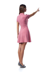 Full length woman in pink dress pointing to the side, back view
