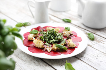 Beet carpaccio with roasted cauliflower and green salad.