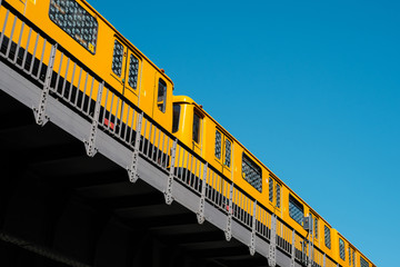 The Berlin U-Bahn train (metro train) U1 on elevated railroad bridge outdoor -