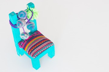 wooden toy chair with andean design and bright colors