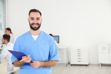 Portrait of medical student with clipboard in scientific laboratory. Space for text