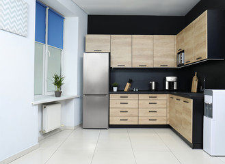 Cozy modern kitchen interior with new furniture and appliances