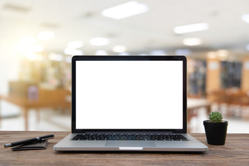 Fototapeta premium Desk Laptop with blank screen on table