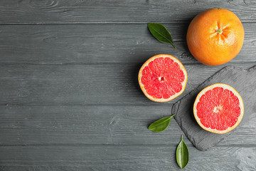 Flat lay composition with grapefruits and space for text on wooden background