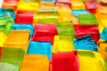 Tasty colorful jelly cubes as background, closeup