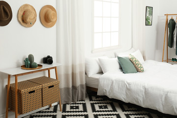 Stylish wooden table and bed in modern room interior