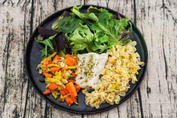 cod fish with vegetables, small vegetables and marine sauce