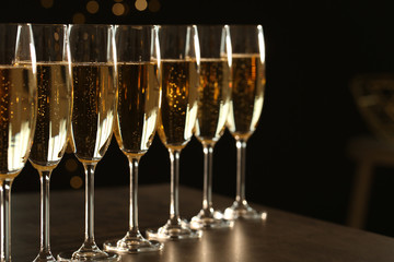 Many glasses of champagne on table. Space for text