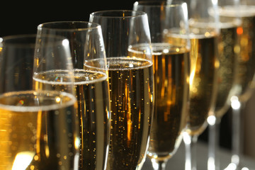 Glasses of champagne on dark background, closeup - obrazy, fototapety, plakaty