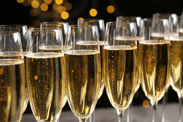Many glasses of champagne on blurred background, closeup