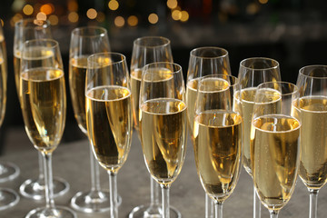 Glasses of champagne on table against blurred background