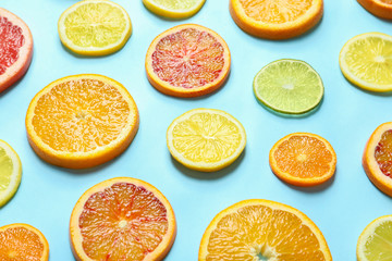 Naklejka na ściany i meble Different citrus fruits on color background, closeup