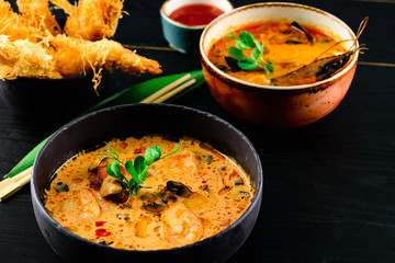 Tom Yam soup and seafood soup, Pan-Asian menu in restaurant. Top View.