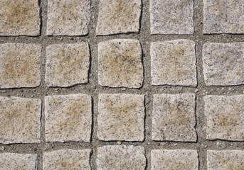 Granite curbstones. gray, brown. square pattern.