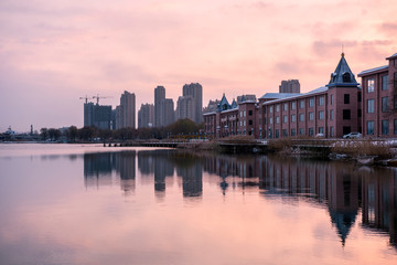 Fototapeta na wymiar Skyline of Waterfront City under Sunset