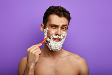 shaving cream which provides superior shaving comfort. close up portrait.habit concept