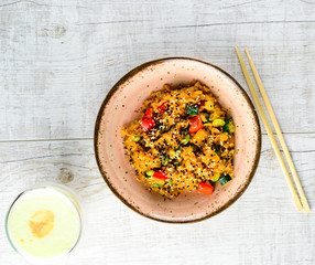 Tyahan - fried rice with chicken and vegetables in a bowl on the table