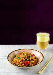 Tyahan - fried rice with chicken and vegetables in a bowl on the table