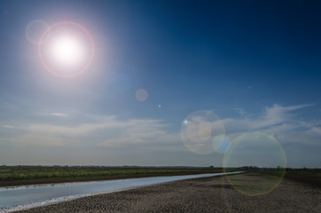 day landscape with river and sun