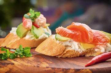 Delicious snacks with shrimp, fish and avocado