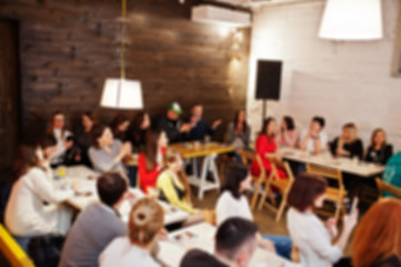 Master class and study concept. Abstract blurred photo of conference or seminar room with speaker on the stage.