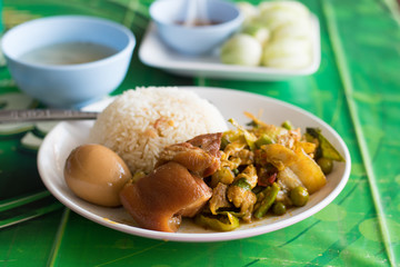Stewed pork and egg with fried pork on rice.Thai street food for poor and workers people