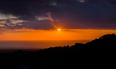This is a capture of a sunset in Beirut and you can see the orange color formed by the sun and the...