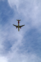 Passenger Airplane flying on cloudy sky