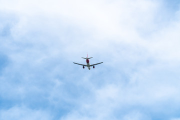 Passenger Airplane flying on cloudy sky