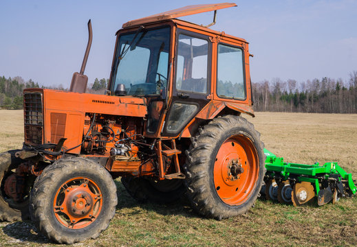 Old tractor for carrying out agricultural work in a field on a farm.