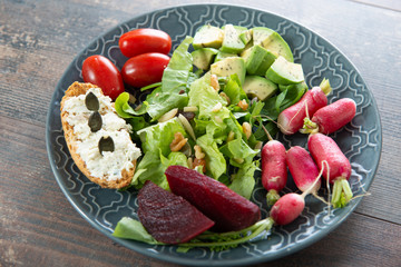 plate with vegetarian salad of natural organic vegetables