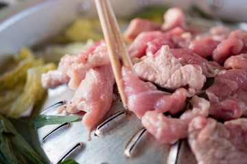 Grilled pork on pan hot pot in soup with morning glory