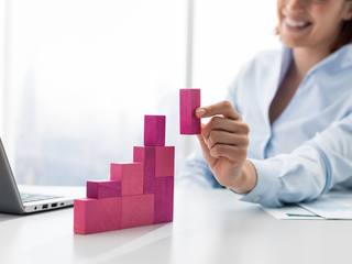 Smiling businesswoman building a successful financial chart