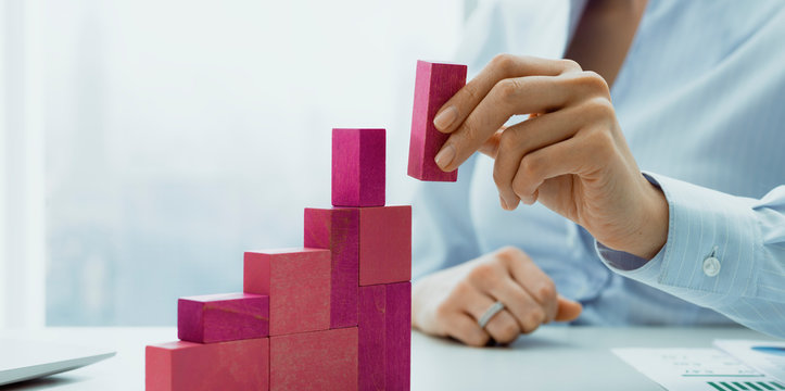 Businesswoman building a growing financial chart