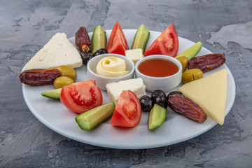 Traditional Ramadan (iftar) foods in ceramic plate.Three different olives,walnuts,date fruits,dry...