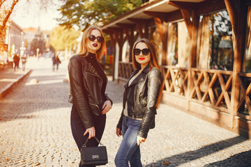 Fototapeta premium two young and pretty girls walking in a summer city
