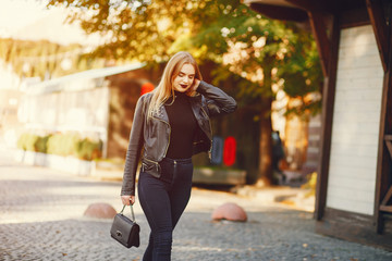 young and pretty girl walking in a summer city