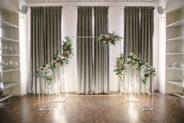 Wedding arch and indoor wedding ceremony. Decoration of the wedding ceremony