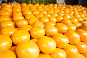 orange fruit stacked on the marketplace