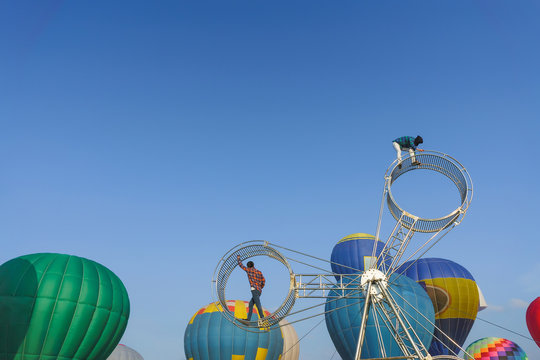 Festival with hot air balloons in the open air. Wheel circus performance. Colorful hot air balloons.