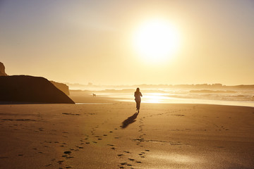 Woman running along the beach