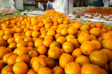 orange fruit stacked on the marketplace