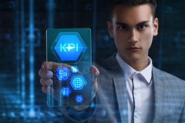 The concept of business, technology, the Internet and the network. A young entrepreneur working on a virtual screen of the future and sees the inscription: KPI