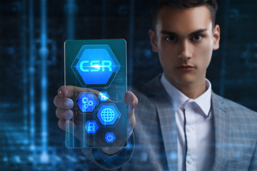 The concept of business, technology, the Internet and the network. A young entrepreneur working on a virtual screen of the future and sees the inscription: CSR