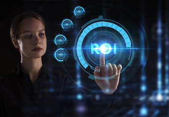 The concept of business, technology, the Internet and the network. A young entrepreneur working on a virtual screen of the future and sees the inscription: ROI