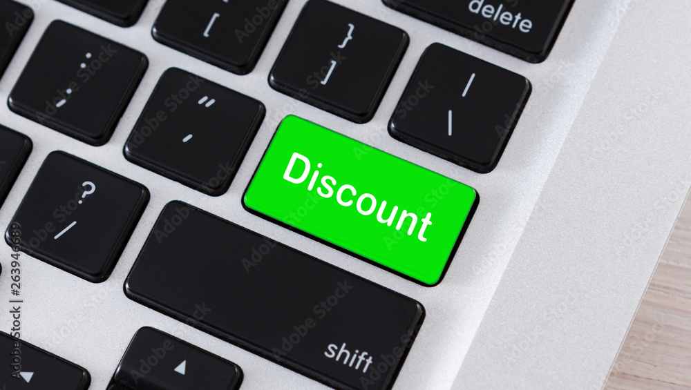 Poster discount word on button of laptop keyboard