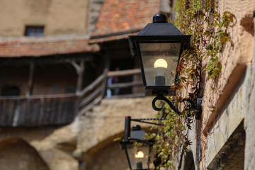 Old street lamps illuminate the way for passersby